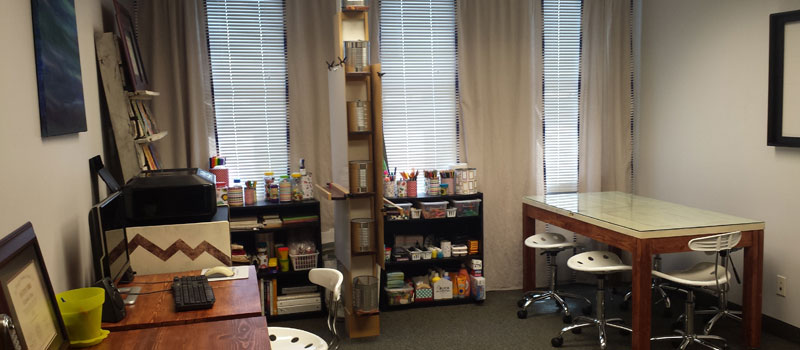 Office with art supplies, work tables, and stools